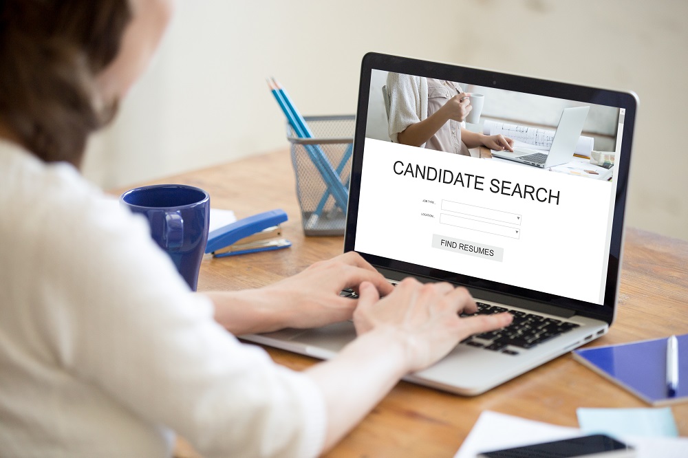 Using AI in recruitment myths and realities. Image of HR searching online for candidates using AI technologies,
