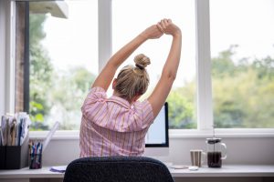 work from home good habits - Image of woman stretching